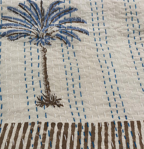 Blue palm bedspread close-up